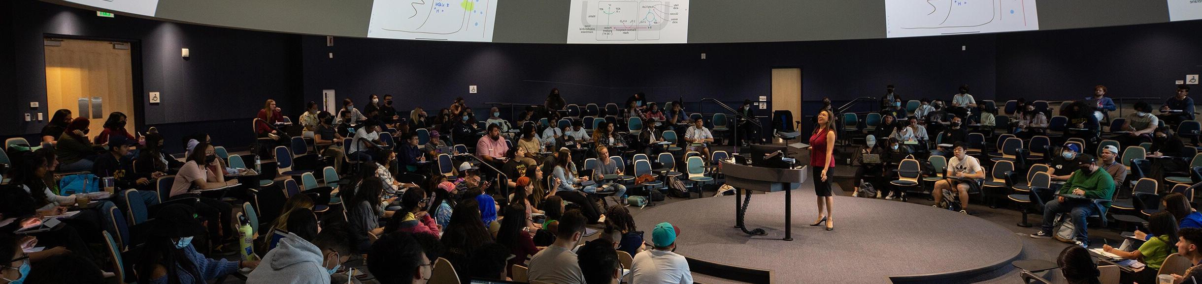 UCR Professor teaching inside of the Student Success Center lecture hall